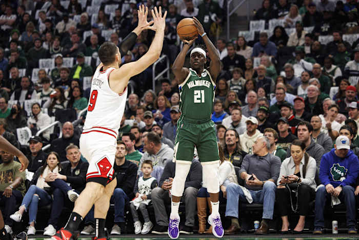 Milwaukee Bucks guard Jrue Holiday (21) shoots against Chicago Bulls center Nikola Vucevic (9)
